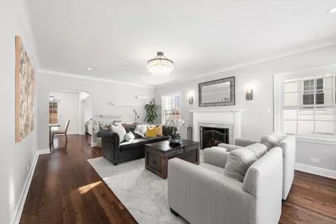 a living room with furniture a fireplace and a window