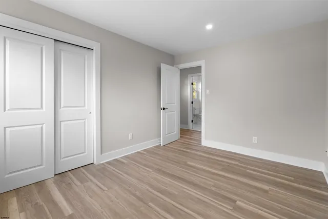 a bathroom with a granite countertop sink toilet a large mirror a bathtub and shower