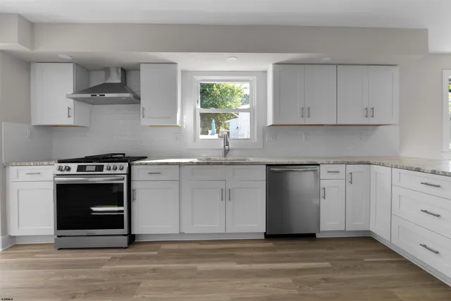 a metallic refrigerator freezer sitting in a kitchen
