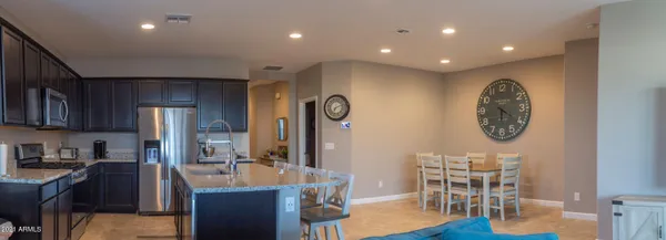 a very nice looking open dining room with kitchen island furniture and a view of kitchen