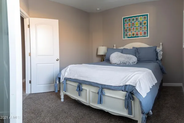a bed sitting in a bedroom next to a window