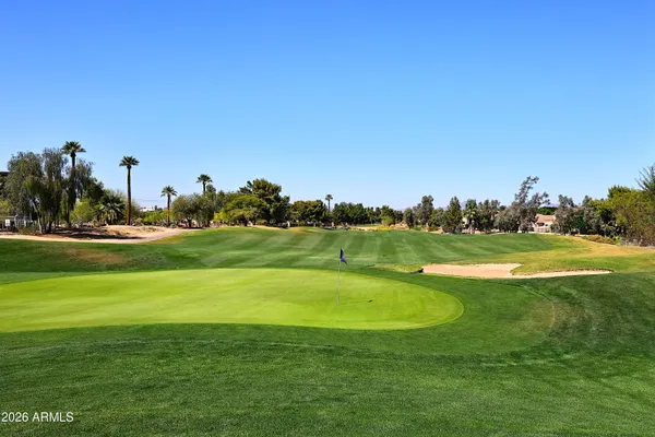 a view of a golf course with a lake