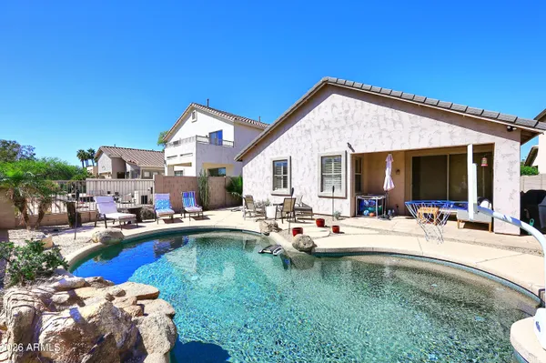 a swimming pool view with seating space