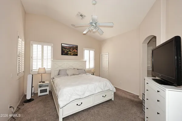 a bedroom with a bed and a flat screen tv