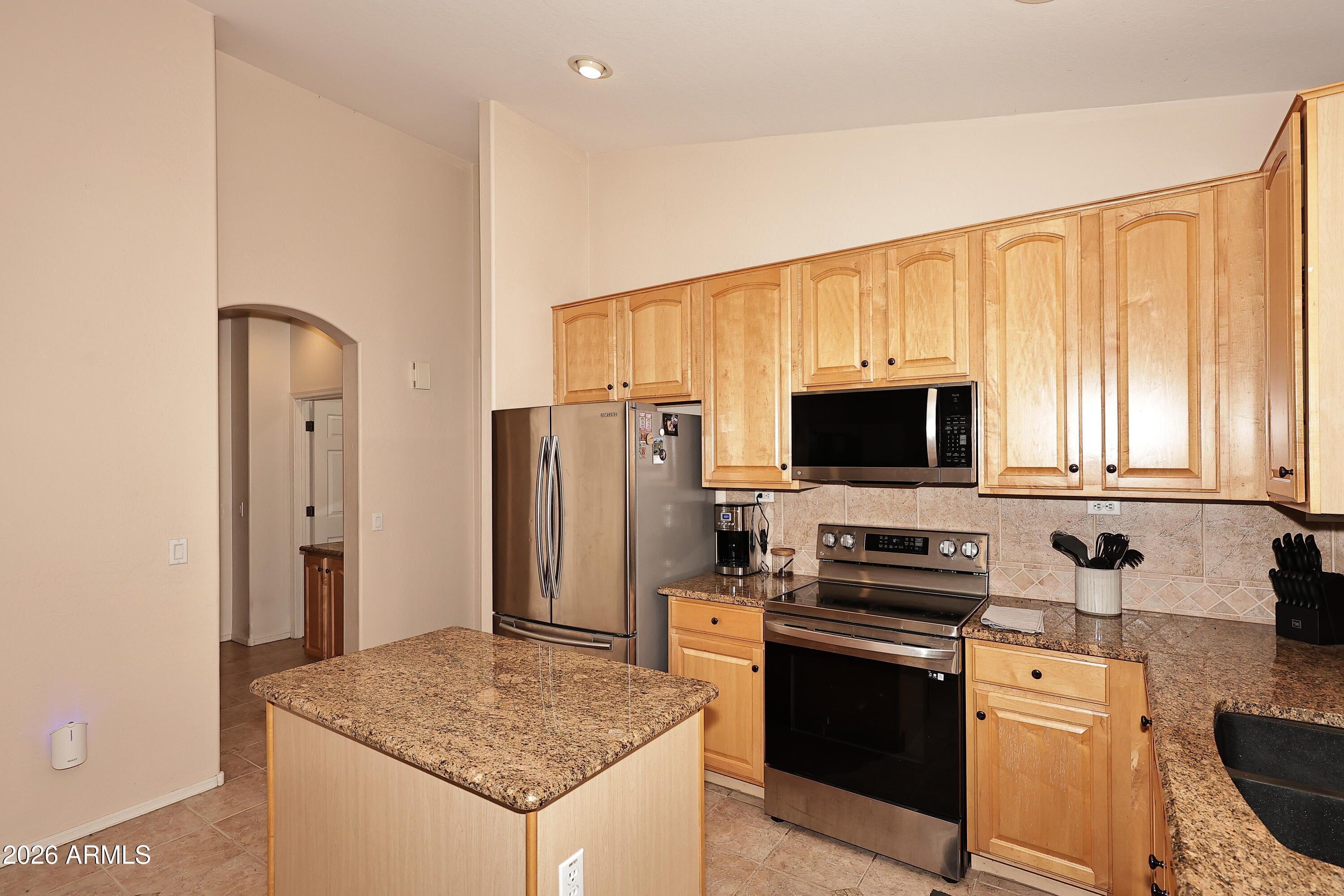 2635 East Darrel Road Phoenix, AZ 85042 - Photo 7 of 27 a kitchen with stainless steel appliances granite countertop a stove a sink and a refrigerator