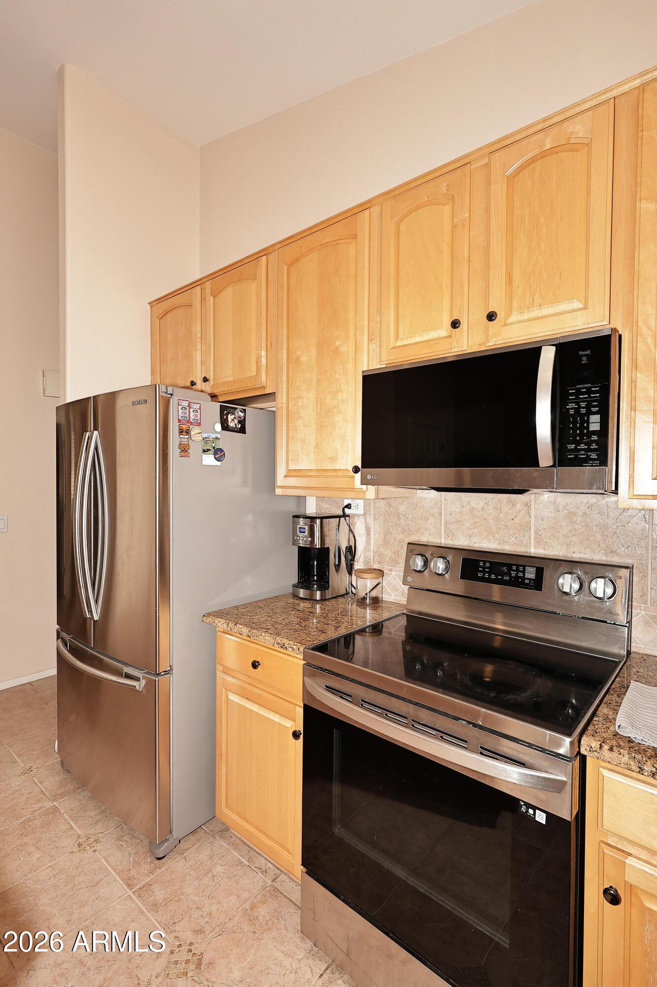 2635 East Darrel Road Phoenix, AZ 85042 - Photo 10 of 27 a kitchen with a stove microwave and refrigerator