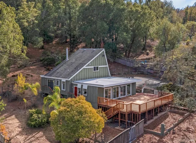 a view of a house with wooden floor and a yard