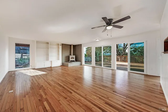 a view of a room with wooden floor and windows