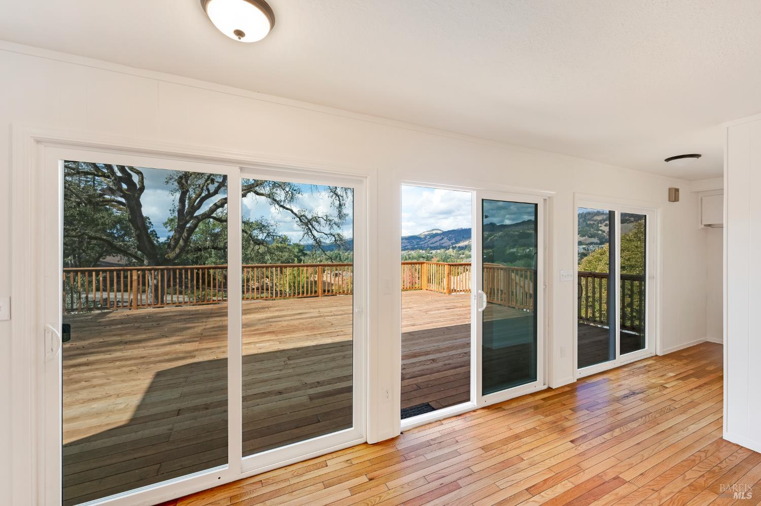5550 Pepperwood Road Santa Rosa, CA 95409 - Photo 12 of 35 a view of a room with wooden floor and windows