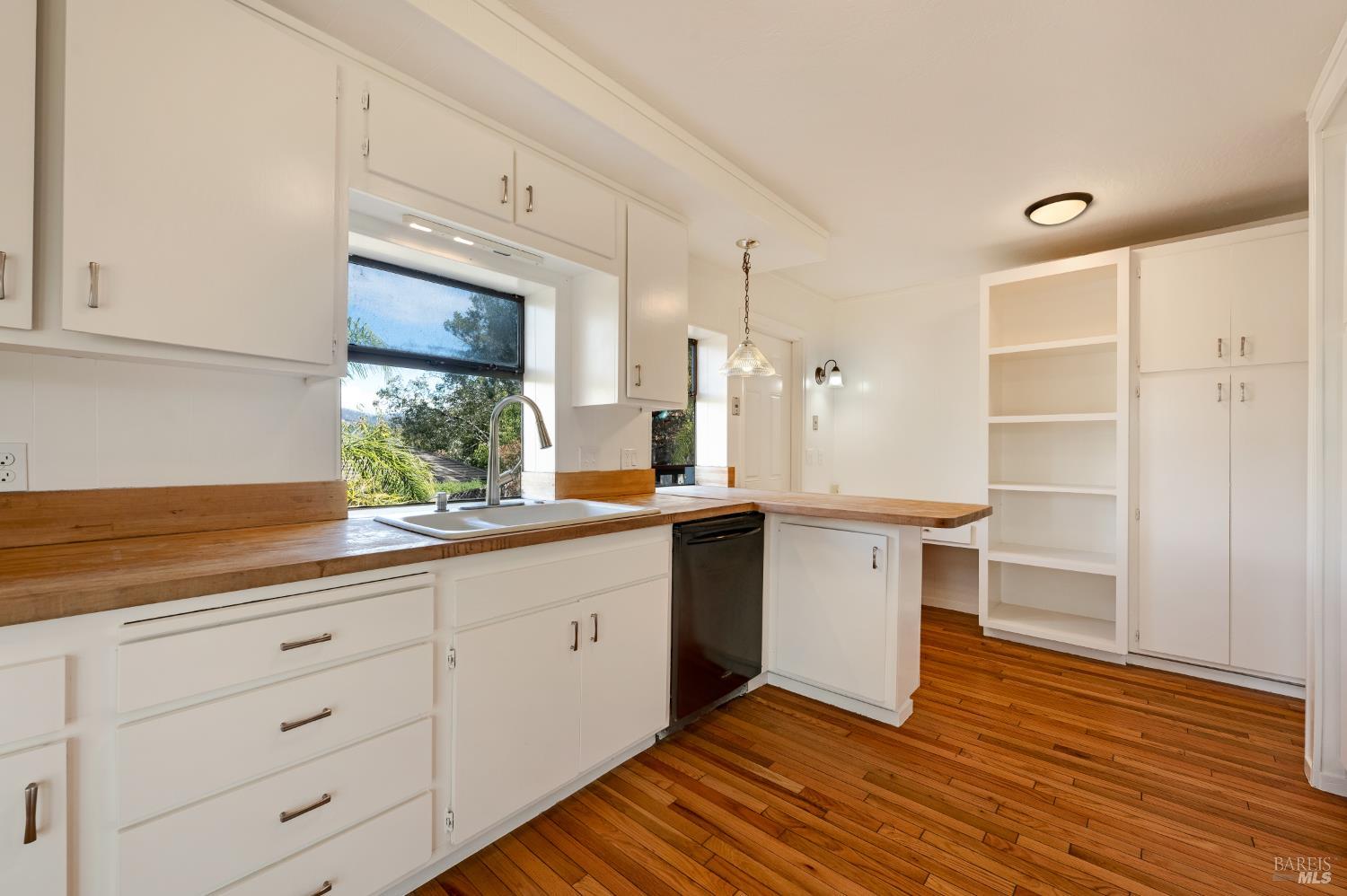 5550 Pepperwood Road Santa Rosa, CA 95409 - Photo 13 of 35 a kitchen with granite countertop white cabinets and white appliances