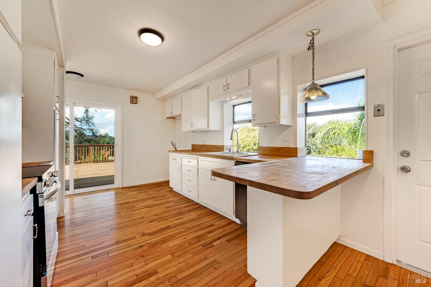 5550 Pepperwood Road Santa Rosa, CA 95409 - Photo 14 of 35 a kitchen with a sink and wooden floor