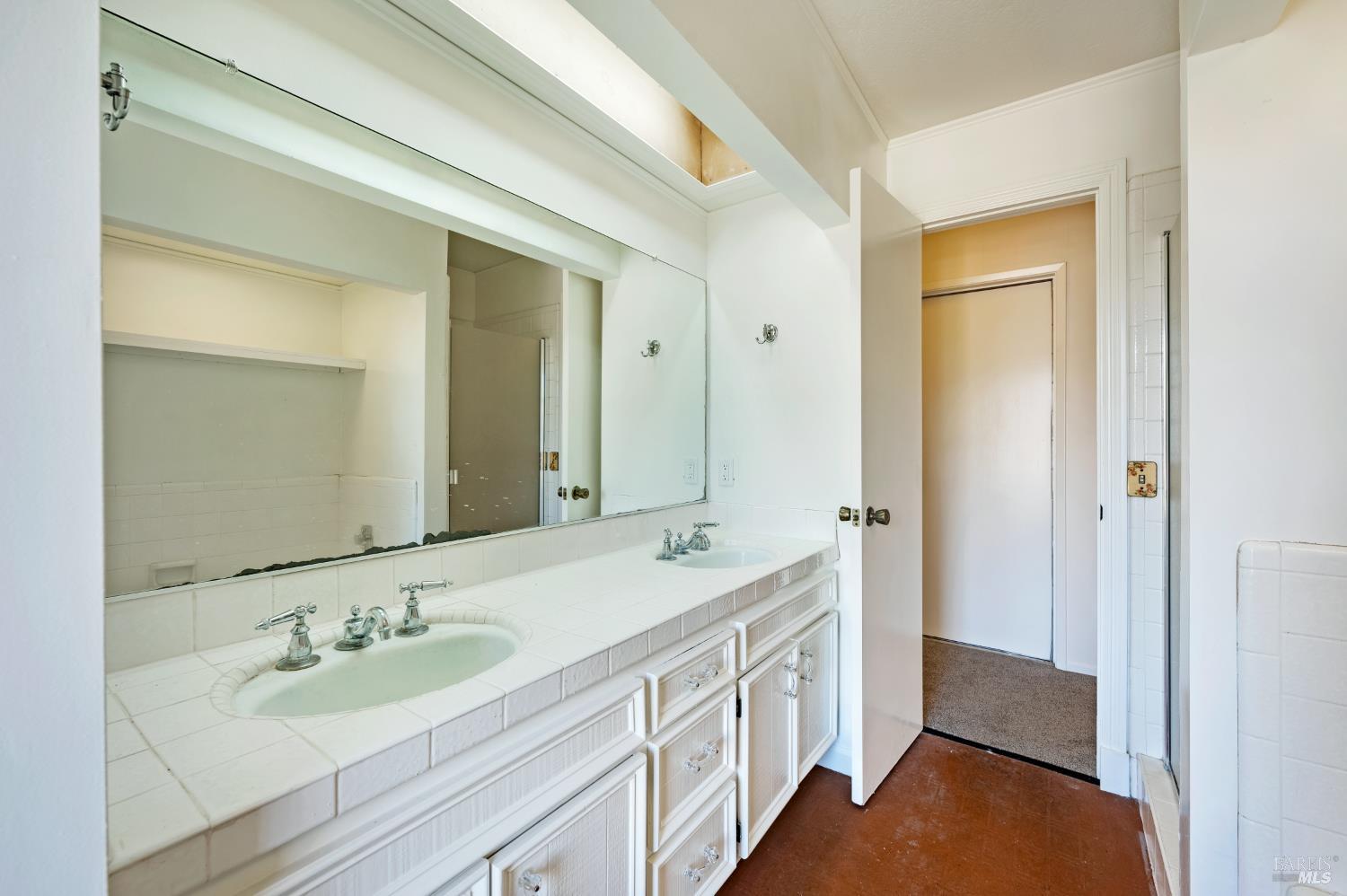 5550 Pepperwood Road Santa Rosa, CA 95409 - Photo 20 of 35 a bathroom with a double vanity sink and a mirror