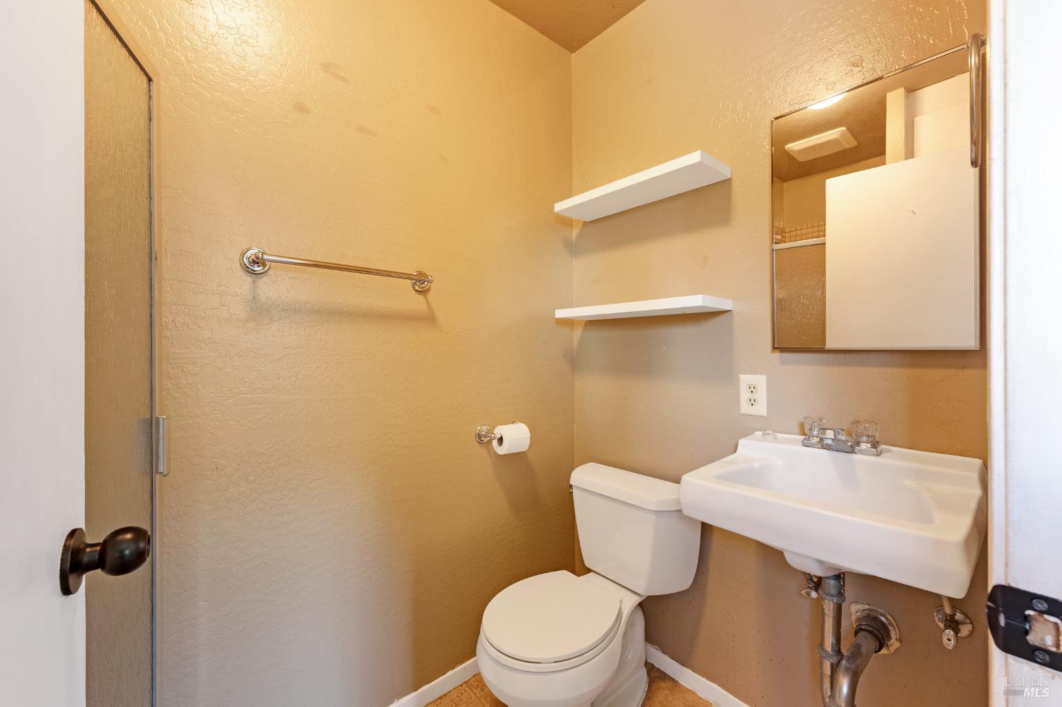 5550 Pepperwood Road Santa Rosa, CA 95409 - Photo 29 of 35 a bathroom with a sink mirror vanity and toilet