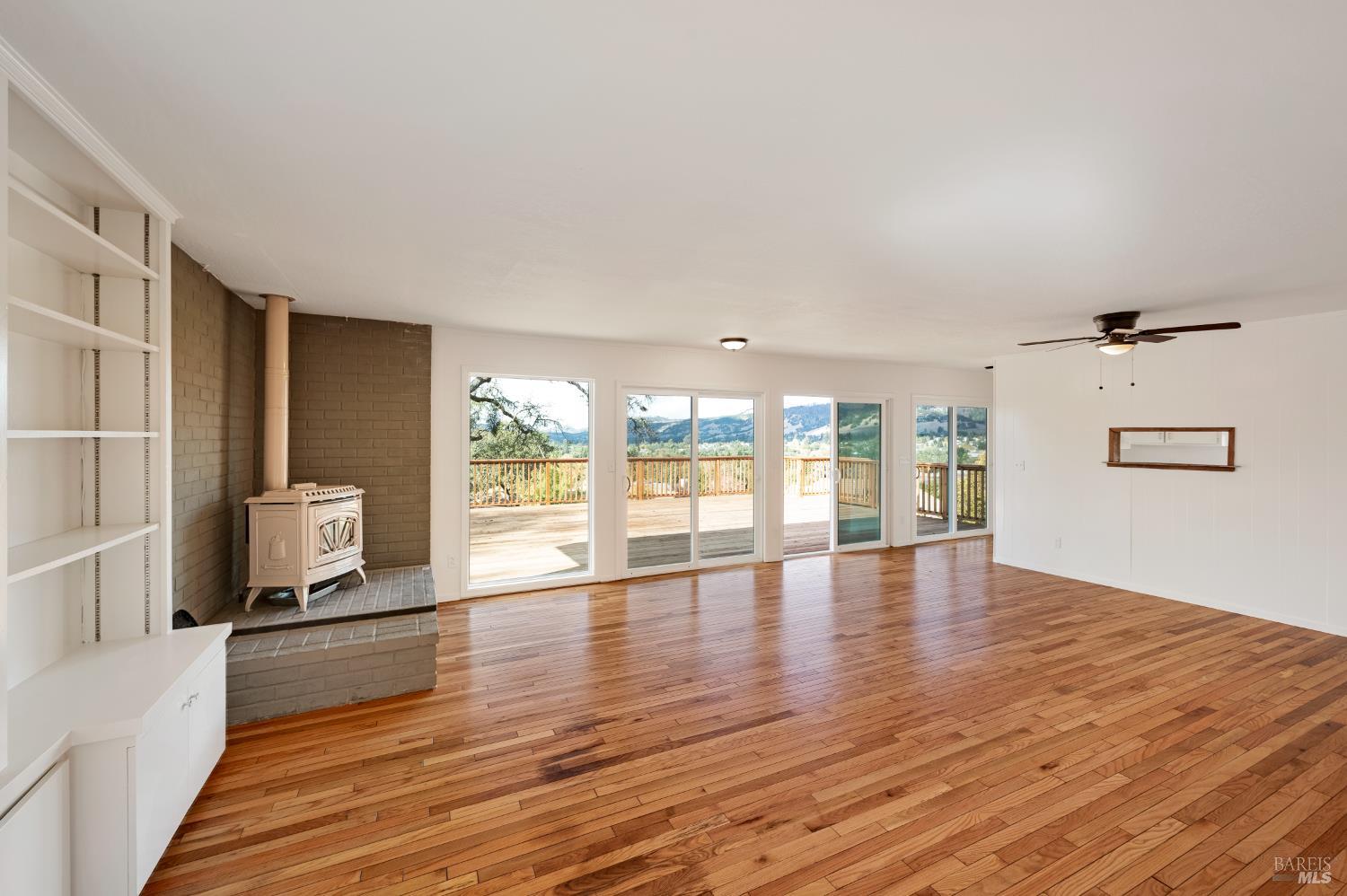 5550 Pepperwood Road Santa Rosa, CA 95409 - Photo 10 of 35 a view of an empty room with wooden floor and a window