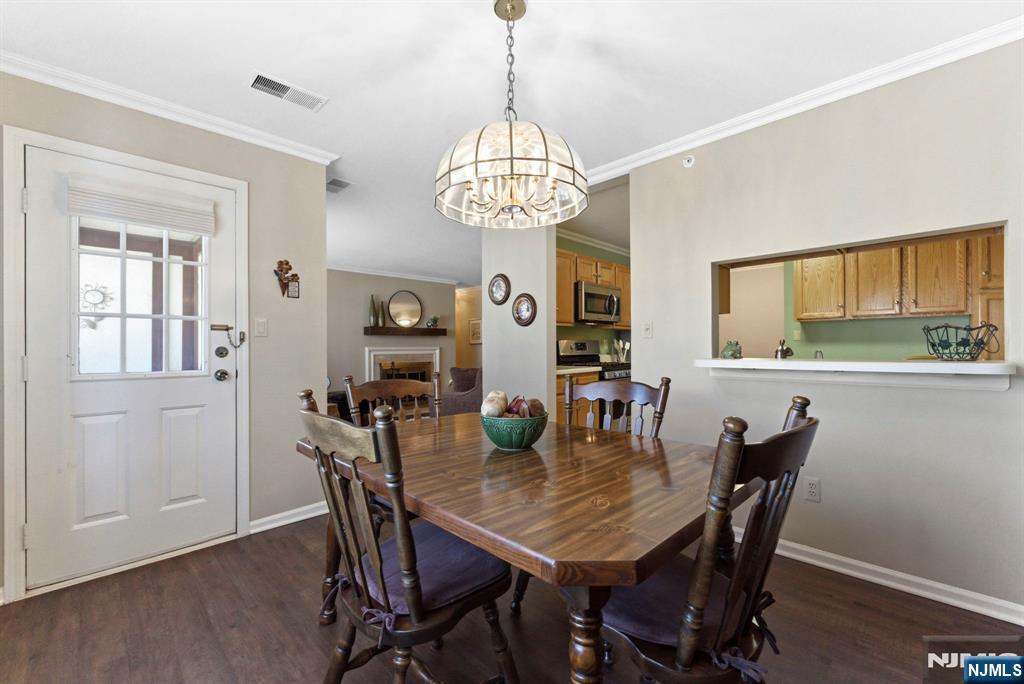 2309 Hemingway Lane, Unit 2309 Mahwah, NJ 07430 - Photo 11 of 28 a view of a dining room with furniture window and wooden floor
