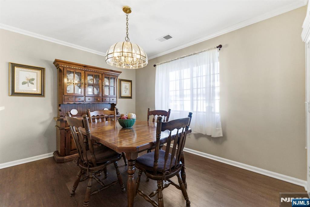 2309 Hemingway Lane, Unit 2309 Mahwah, NJ 07430 - Photo 12 of 28 a view of a dining room with furniture window and wooden floor