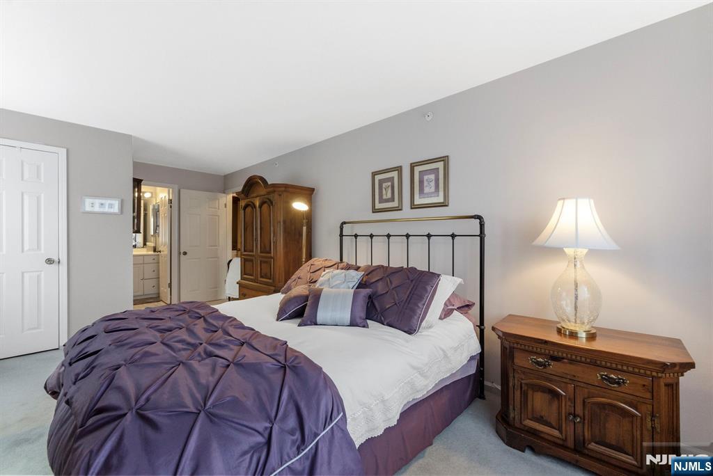 2309 Hemingway Lane, Unit 2309 Mahwah, NJ 07430 - Photo 13 of 28 a bedroom with a bed and a lamp