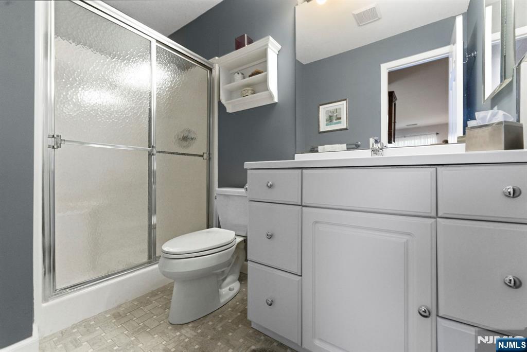 2309 Hemingway Lane, Unit 2309 Mahwah, NJ 07430 - Photo 15 of 28 a bathroom with a sink toilet and shower