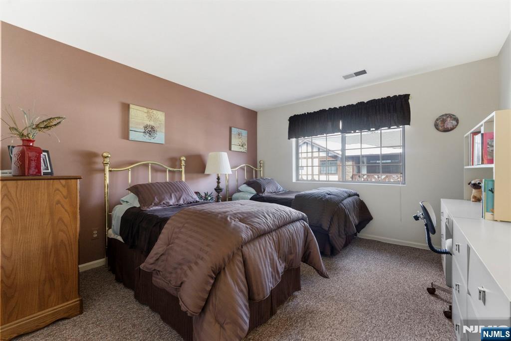 2309 Hemingway Lane, Unit 2309 Mahwah, NJ 07430 - Photo 16 of 28 a bedroom with two beds and a window