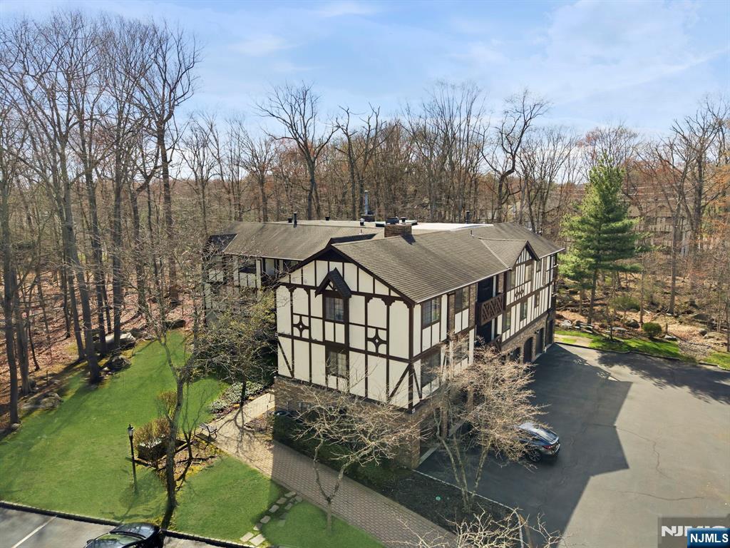 2309 Hemingway Lane, Unit 2309 Mahwah, NJ 07430 - Photo 2 of 28 a view of a patio with chairs next to a yard