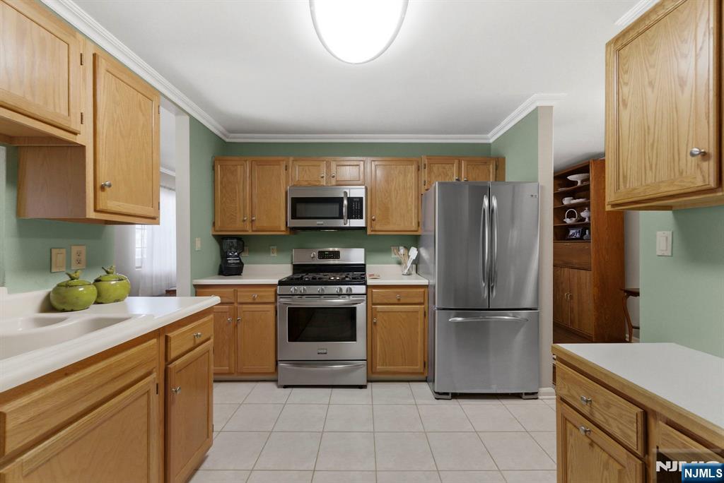 2309 Hemingway Lane, Unit 2309 Mahwah, NJ 07430 - Photo 4 of 28 a kitchen with stainless steel appliances granite countertop a refrigerator sink and stove