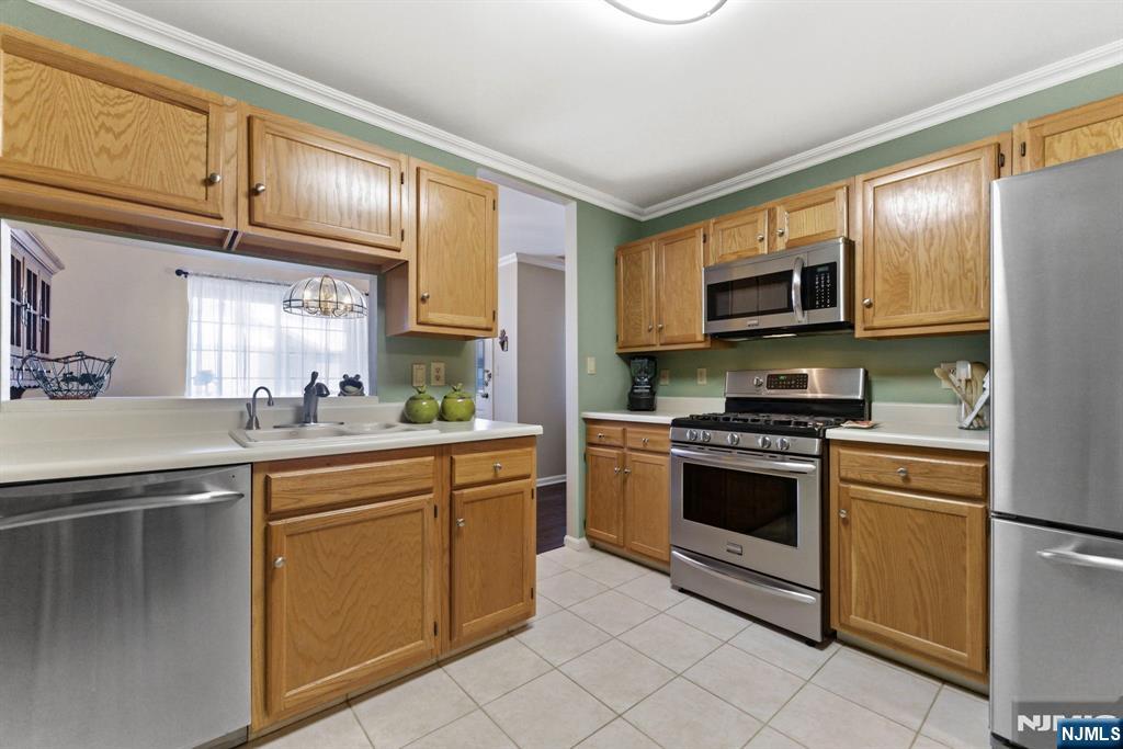 2309 Hemingway Lane, Unit 2309 Mahwah, NJ 07430 - Photo 6 of 28 a kitchen with stainless steel appliances granite countertop a stove top oven a sink and dishwasher