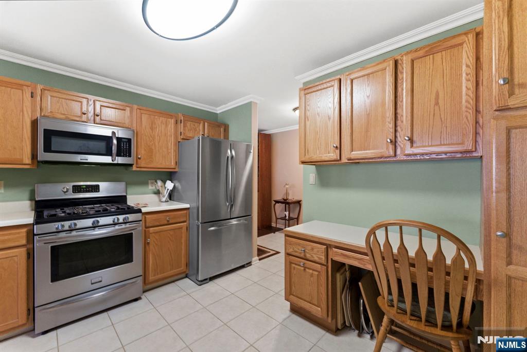 2309 Hemingway Lane, Unit 2309 Mahwah, NJ 07430 - Photo 7 of 28 a kitchen with stainless steel appliances granite countertop a stove top oven a refrigerator and a microwave