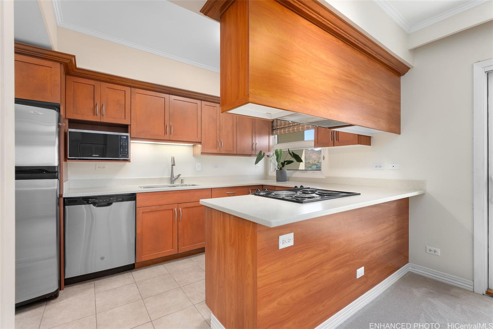 21 Craigside Place, Unit 8D Honolulu, HI 96817 - Photo 7 of 25 a kitchen with stainless steel appliances granite countertop a stove a sink and a microwave