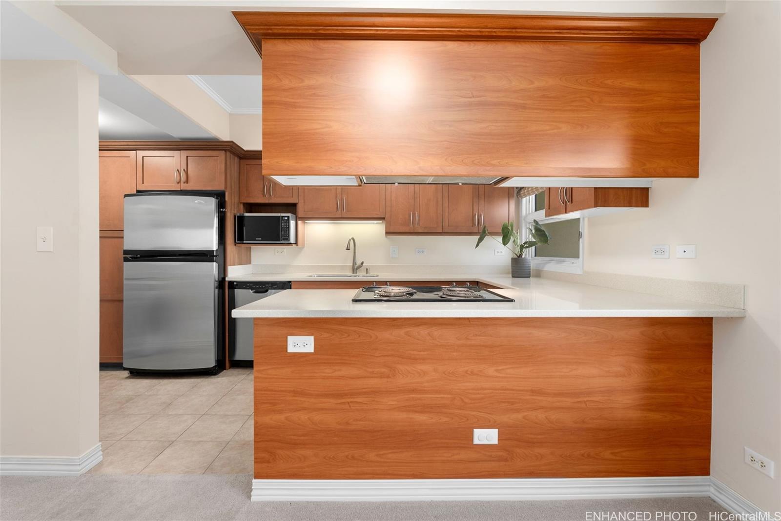 21 Craigside Place, Unit 8D Honolulu, HI 96817 - Photo 8 of 25 a kitchen with a stove and a refrigerator