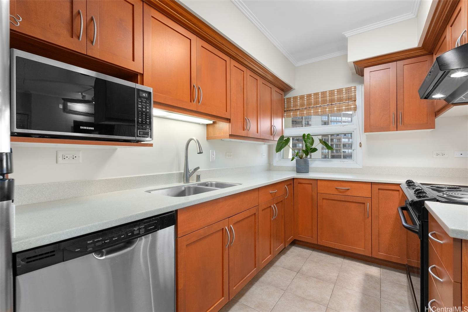 21 Craigside Place, Unit 8D Honolulu, HI 96817 - Photo 10 of 25 a kitchen with stainless steel appliances granite countertop a sink stove and microwave