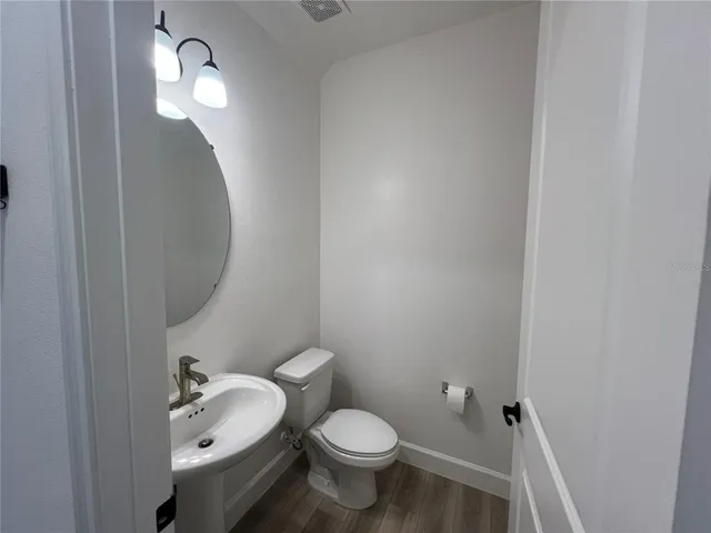 a bathroom with a toilet a sink and view
