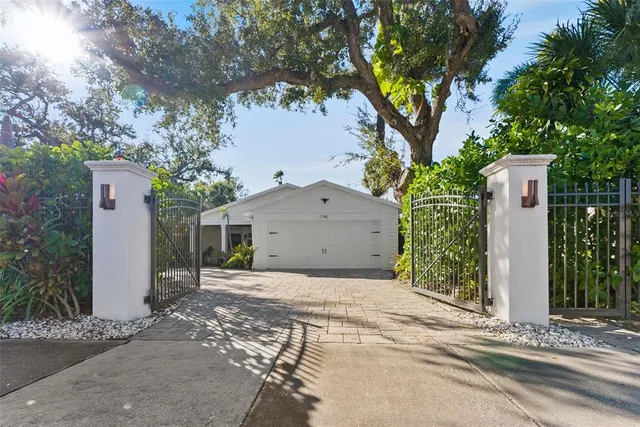 a view of a house with a tree in front