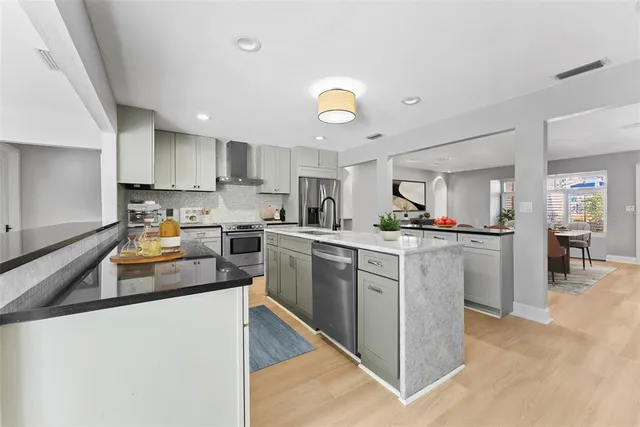 a living room with furniture and large windows
