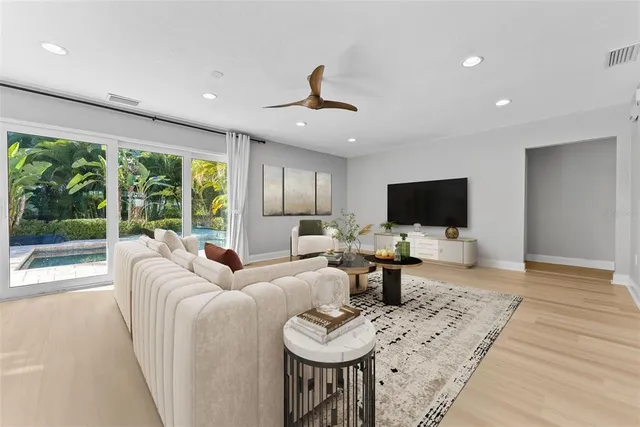 a spacious bedroom with a bed and a ceiling fan