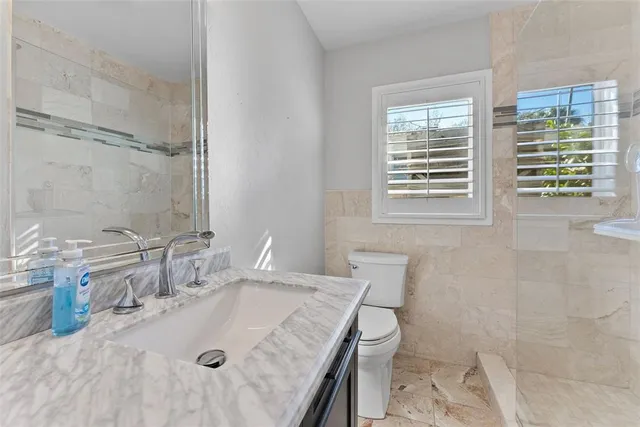 a living room with a bed furniture and a flat screen tv