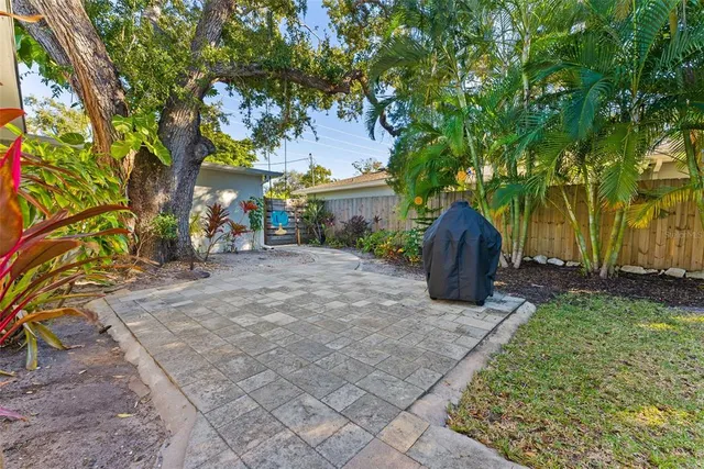 a front view of a house with a yard and potted plants