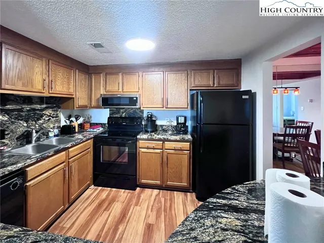 a kitchen with a refrigerator stove and sink
