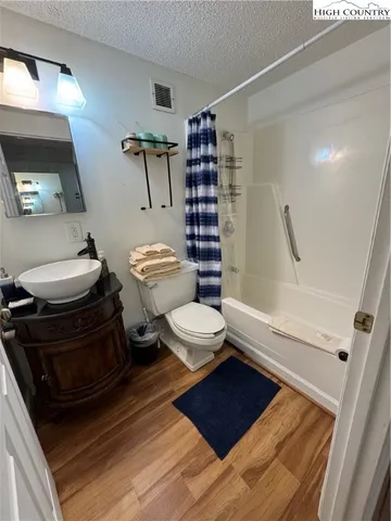 a bathroom with a toilet a sink and shower