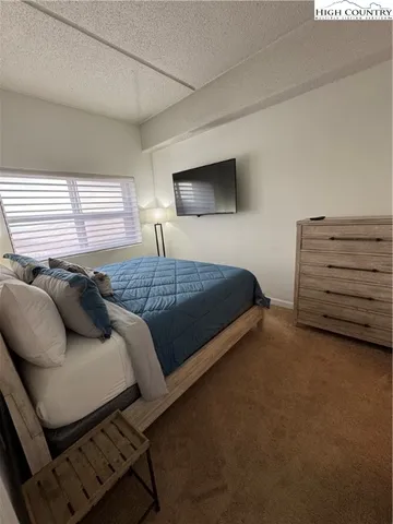 a bedroom with a bed and a night stand