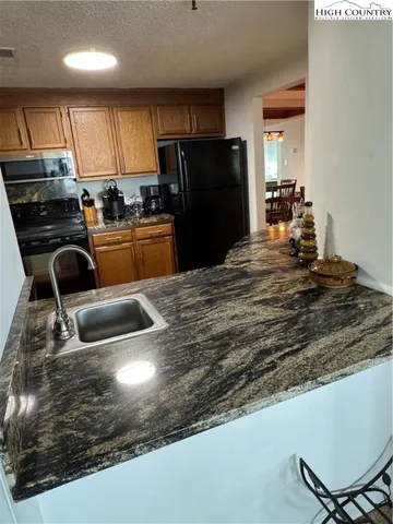 a kitchen with kitchen island a counter top space appliances and cabinets