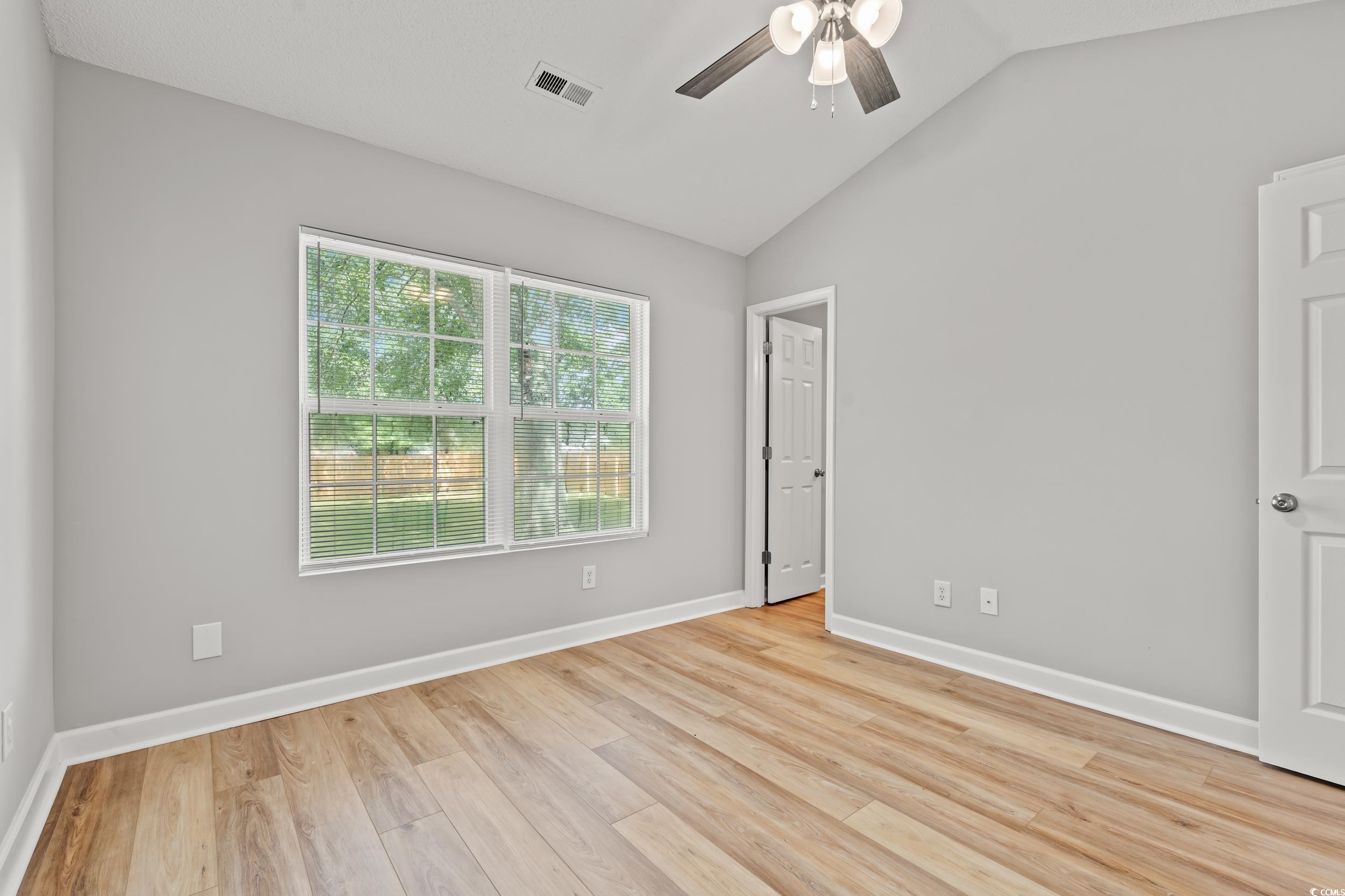 2965 Mt Olive Road Loris, SC 29569 - Photo 16 of 35 Empty room featuring a ceiling fan, vaulted ceilin