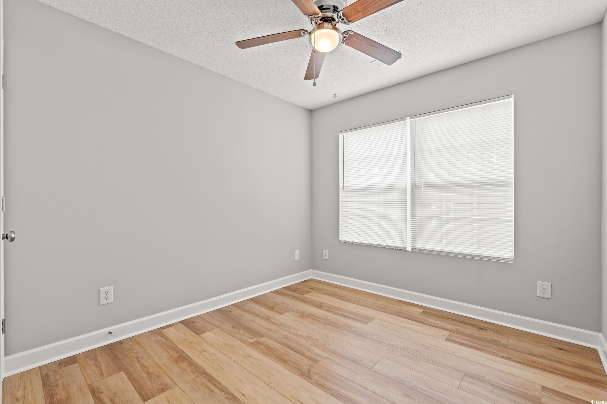 2965 Mt Olive Road Loris, SC 29569 - Photo 19 of 35 Empty room with a ceiling fan, light wood-style fl