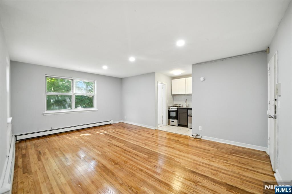 819 Bloomfield Avenue, Unit 12 Montclair, NJ 07042 - Photo 6 of 9 a view of an empty room with a window and wooden floor