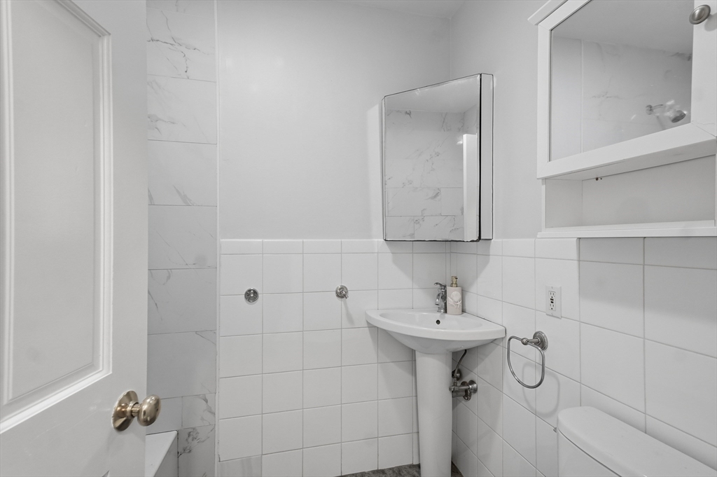 55 Addison Avenue Lynn, MA 01902 - Photo 15 of 23 a bathroom with a sink and mirror