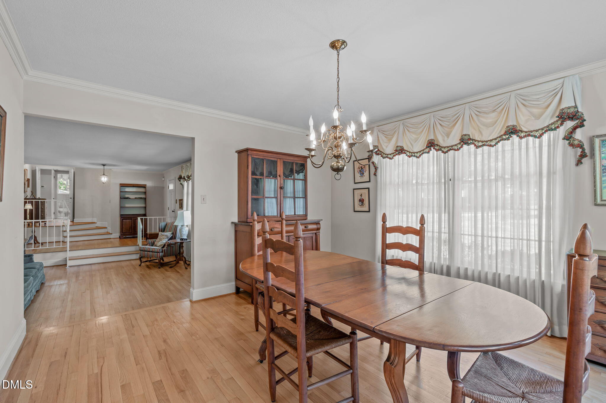 1205 Kimberly Drive Raleigh, NC 27609 - Photo 15 of 45 a view of a dining room with furniture wooden floor and chandelier