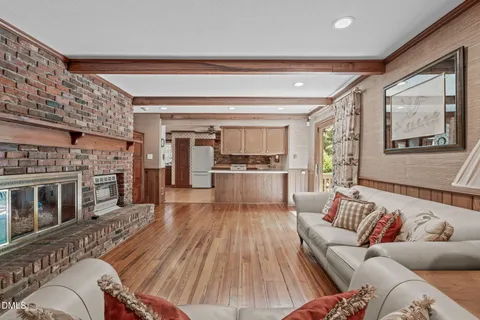 a view of a dining room with furniture wooden floor and chandelier