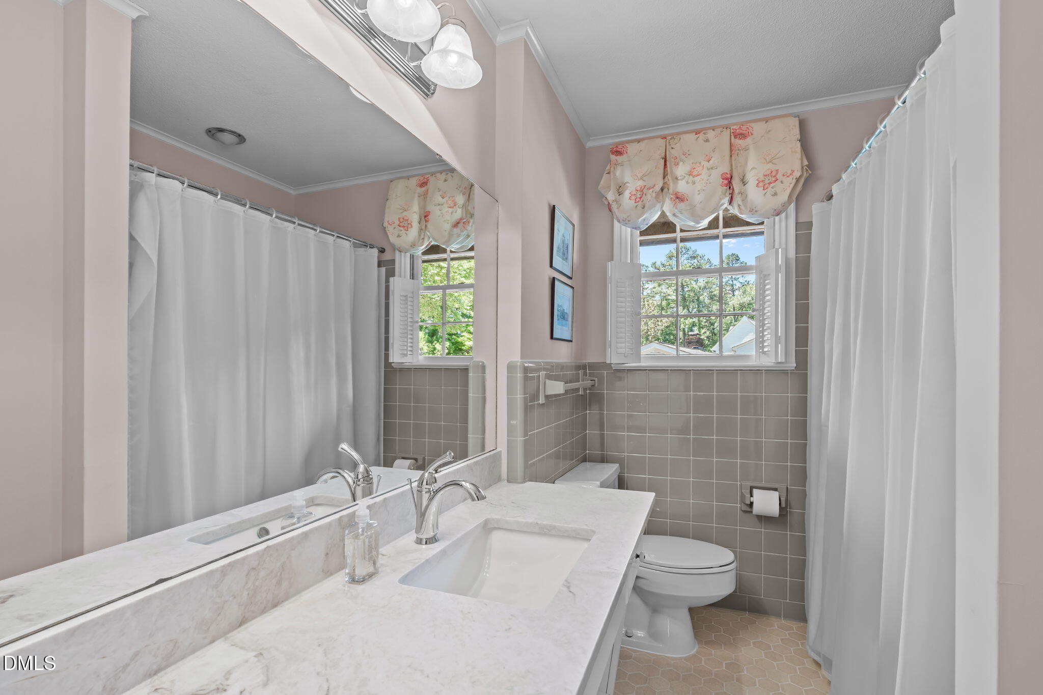 1205 Kimberly Drive Raleigh, NC 27609 - Photo 27 of 45 a bathroom with a toilet a sink and tub