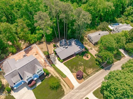 an aerial view of a house with yard and mountain view in back