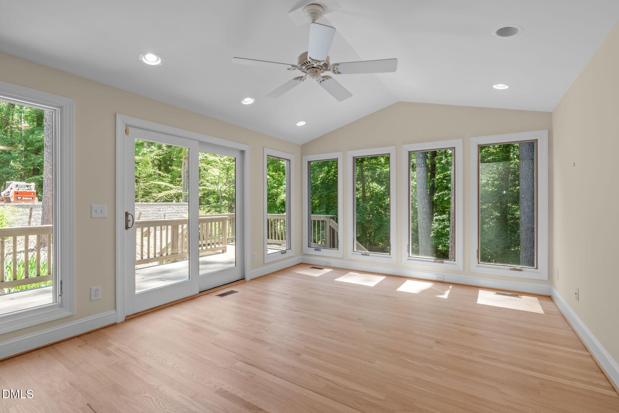 1205 Kimberly Drive Raleigh, NC 27609 - Photo 5 of 45 a view of an empty room with wooden floor and a window