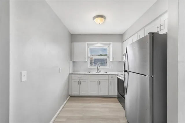 a white refrigerator freezer sitting inside of a kitchen